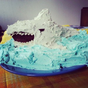 3D chocolate cake with a lot of blue and white icing in form of a shark