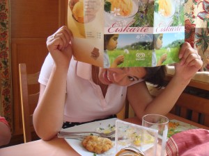 J sitting with an icecream menu in front of her face